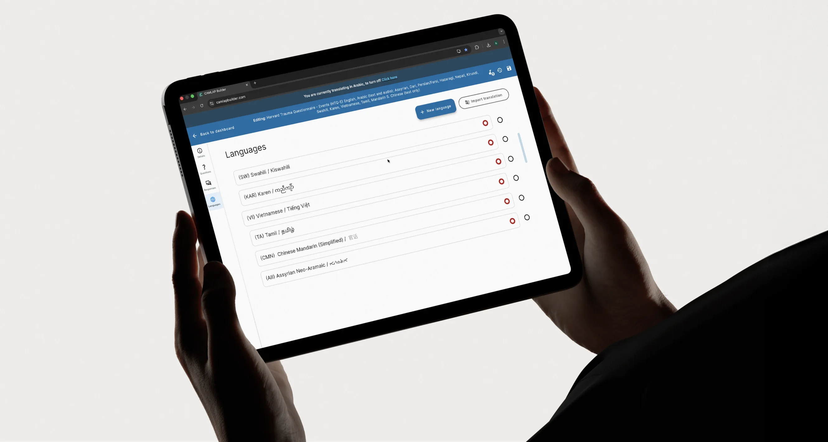 A tablet showing CAMLAP's language selection screen for the STARTTS clinical platform